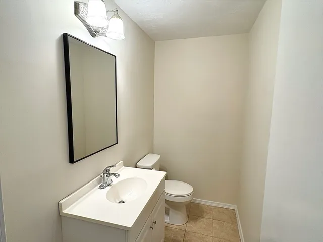a bathroom with a sink a toilet and mirror