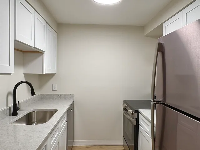 a kitchen with a refrigerator and a sink