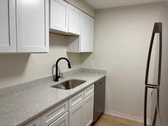 a close view of a sink and a vanity in the kitchen