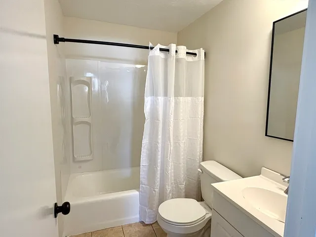 a white toilet sitting next to a bath tub shower