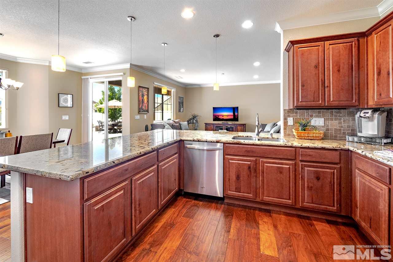 2260 Makenna Drive Reno, NV 89521 - Photo 11 of 27 a kitchen with stainless steel appliances granite countertop wooden cabinets a sink and dishwasher