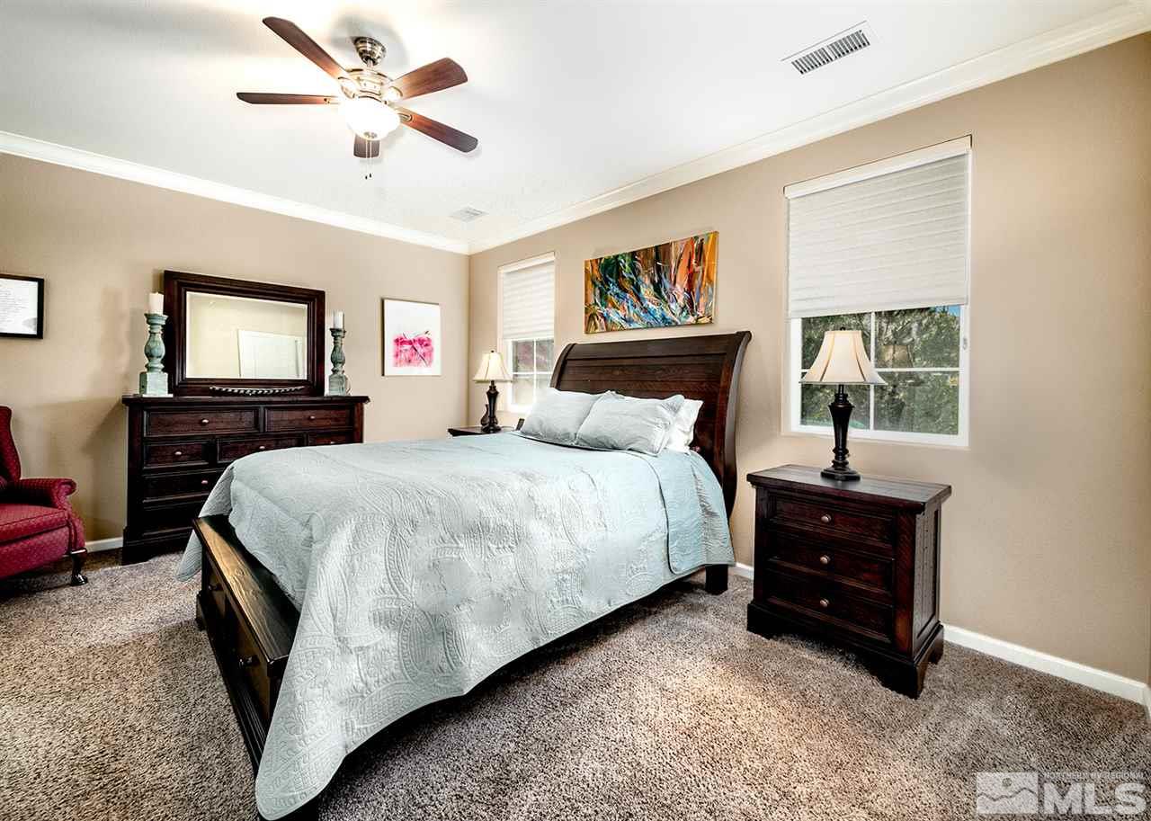2260 Makenna Drive Reno, NV 89521 - Photo 14 of 27 a bedroom with a bed and a chandelier