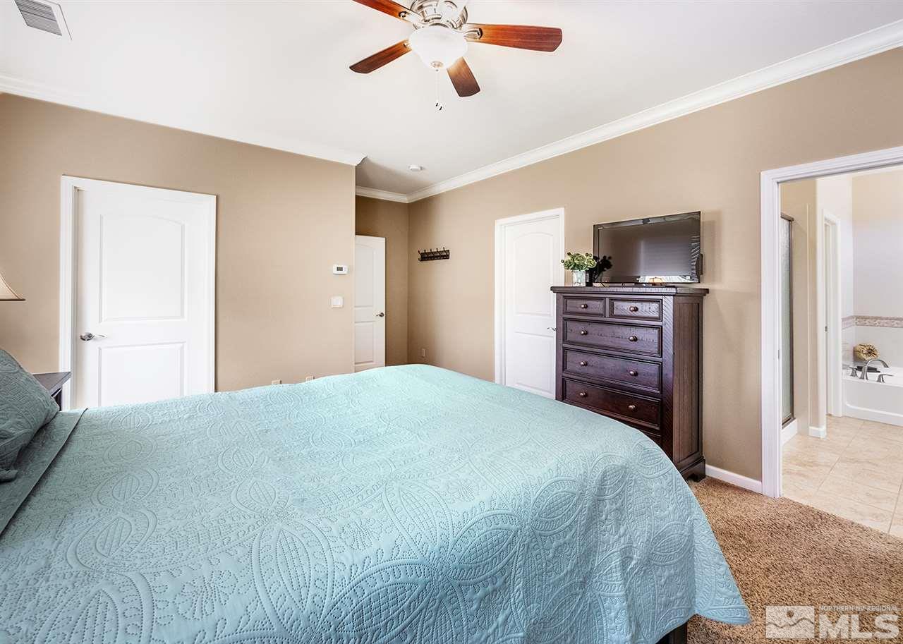 2260 Makenna Drive Reno, NV 89521 - Photo 15 of 27 a bedroom with a bed and a flat screen tv