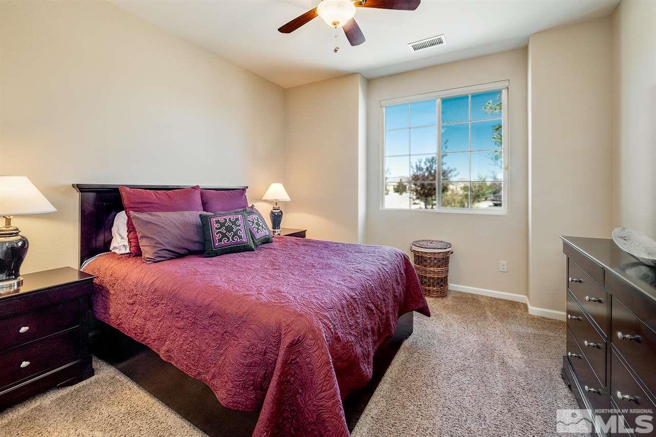 2260 Makenna Drive Reno, NV 89521 - Photo 18 of 27 a bedroom with a bed and a chandelier