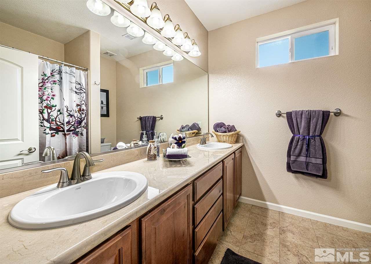 2260 Makenna Drive Reno, NV 89521 - Photo 19 of 27 a bathroom with a double vanity sink and a mirror