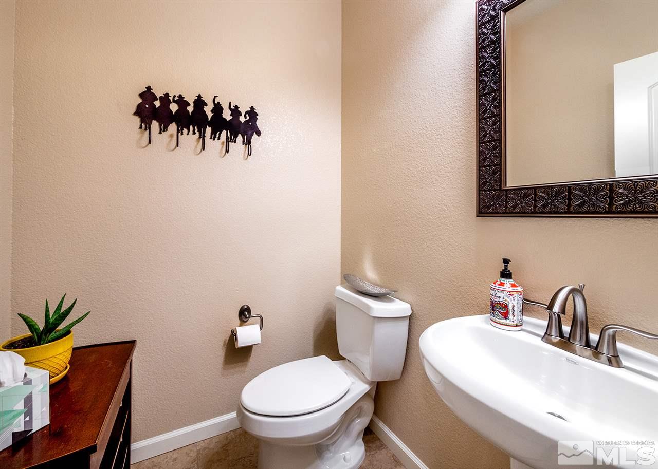 2260 Makenna Drive Reno, NV 89521 - Photo 9 of 27 a bathroom with a toilet sink and mirror