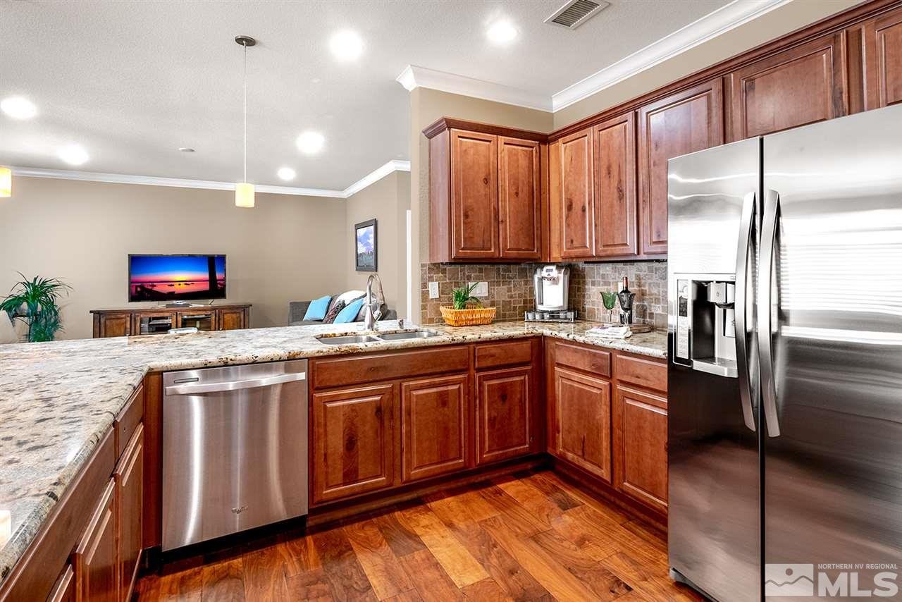 2260 Makenna Drive Reno, NV 89521 - Photo 10 of 27 a kitchen with stainless steel appliances granite countertop a stove a sink and a refrigerator