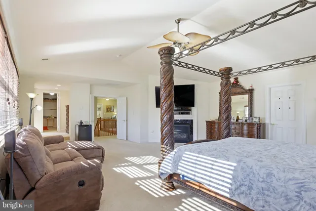 a living room with furniture a flat screen tv and a chandelier