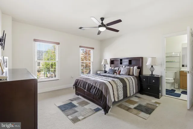 a spacious bedroom with a bed and wooden floor