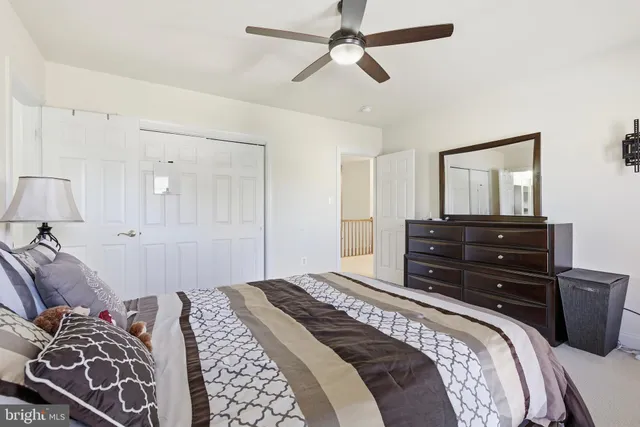 a bedroom with a bed and dresser