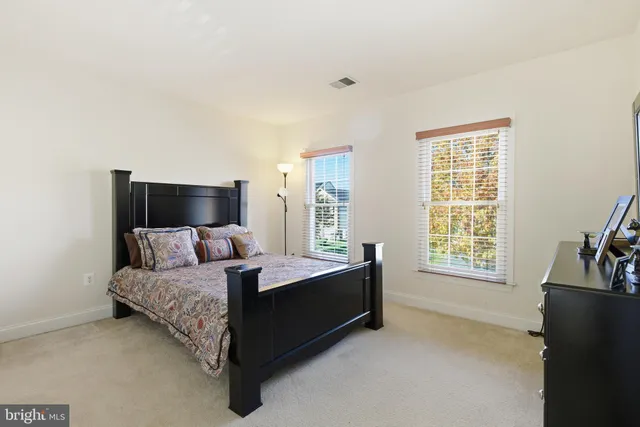a living room with a bed furniture and a flat screen tv