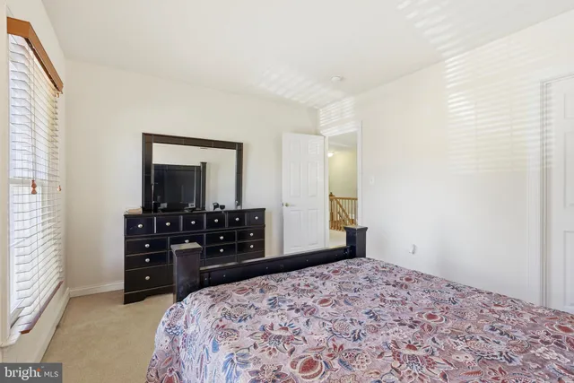 a bedroom with a bed and a television