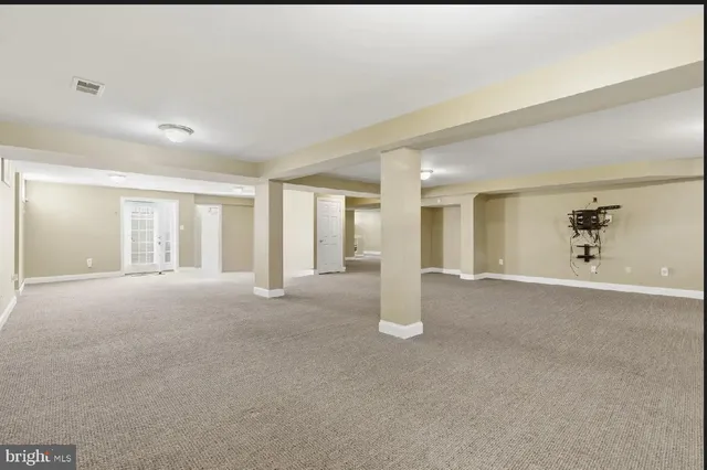 a view of a big room with windows and chandelier