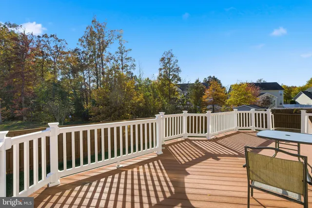 a view of balcony with wooden floor and outdoor seating