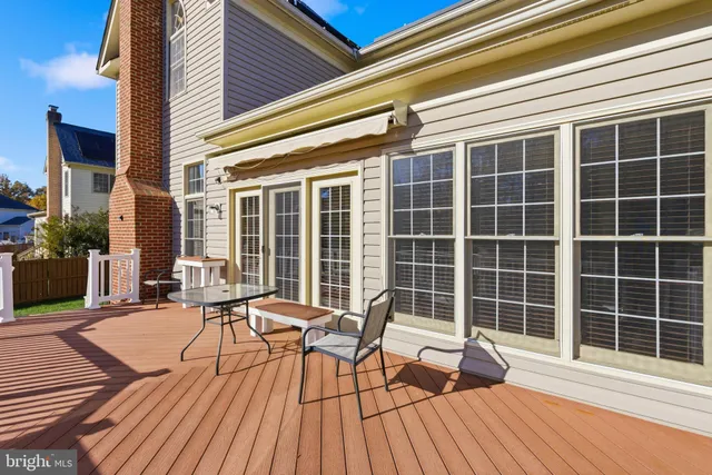a view of a deck with wooden floor and furniture