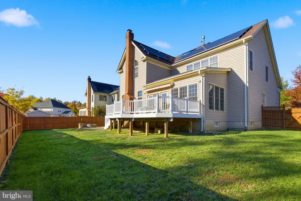 a view of house with a yard