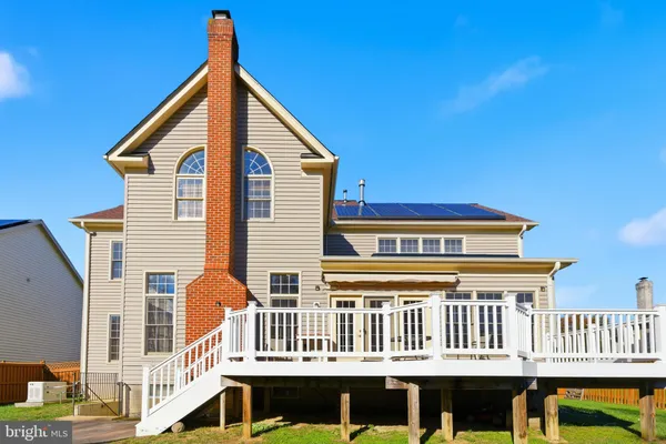 a view of a house with a wooden deck