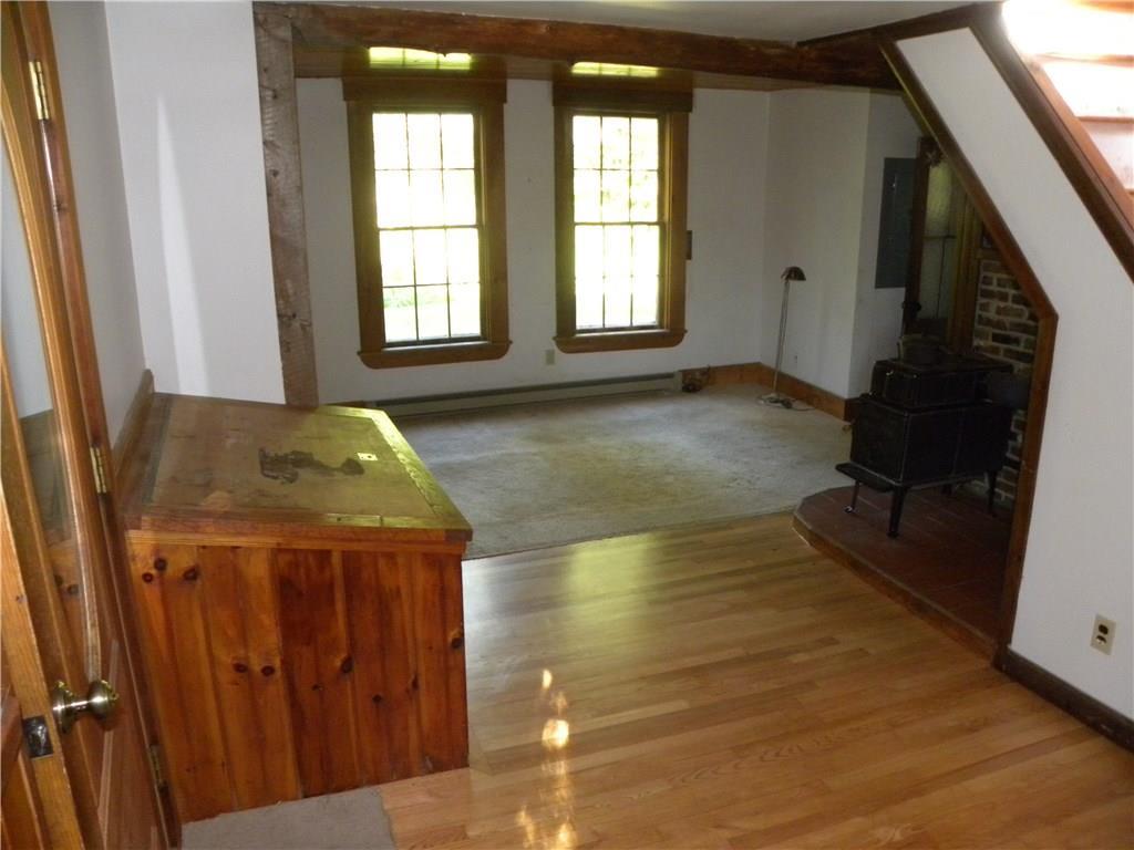 1968 Appleton Ridge Road Appleton, ME 04862 - Photo 6 of 33 Living room, (wood box to left feeds...
