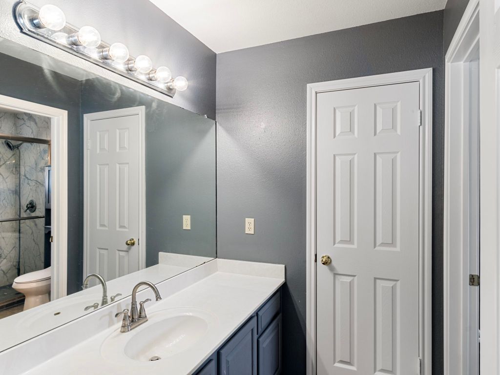 410 Steeplechase Drive Georgetown, TX 78626 - Photo 11 of 15 a bathroom with a sink vanity and a mirror