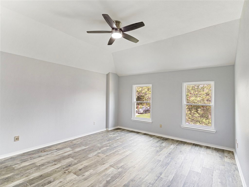 410 Steeplechase Drive Georgetown, TX 78626 - Photo 13 of 15 wooden floor in an empty room with a window