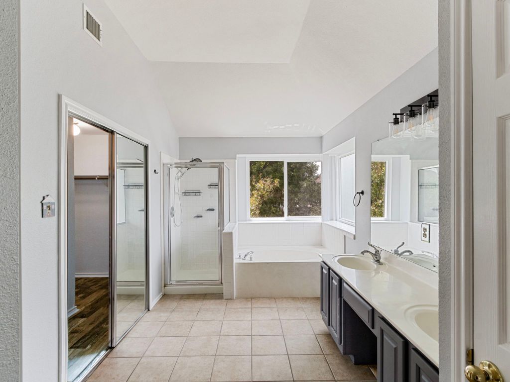 410 Steeplechase Drive Georgetown, TX 78626 - Photo 14 of 15 a bathroom with a tub sink shower and a mirror