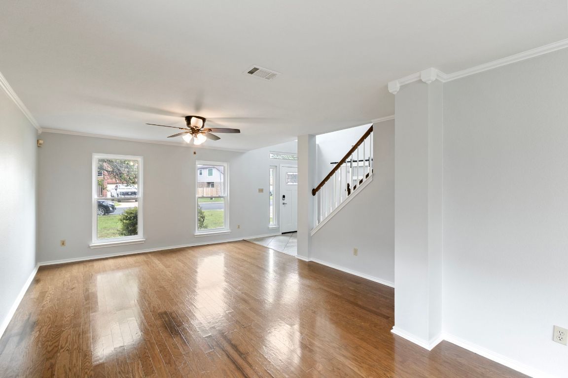 410 Steeplechase Drive Georgetown, TX 78626 - Photo 3 of 15 a view of an empty room with wooden floor and a window