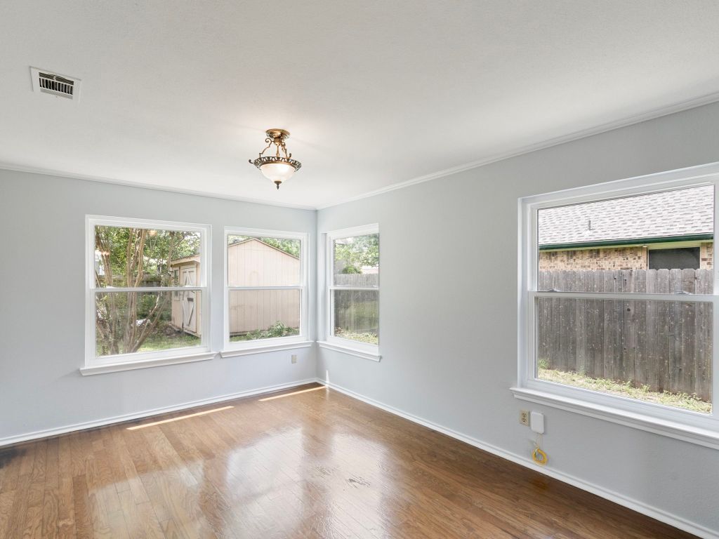 410 Steeplechase Drive Georgetown, TX 78626 - Photo 4 of 15 a view of an empty room with a window and wooden floor