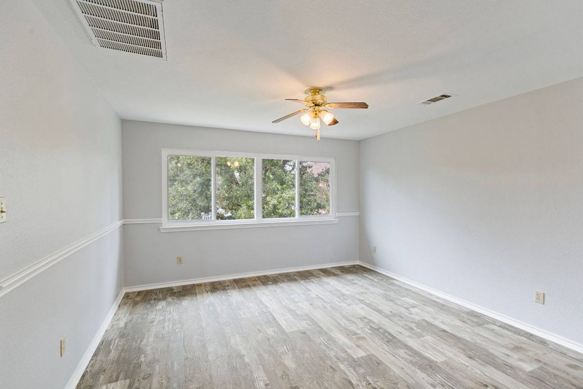 410 Steeplechase Drive Georgetown, TX 78626 - Photo 8 of 15 an empty room with a window and a ceiling fan