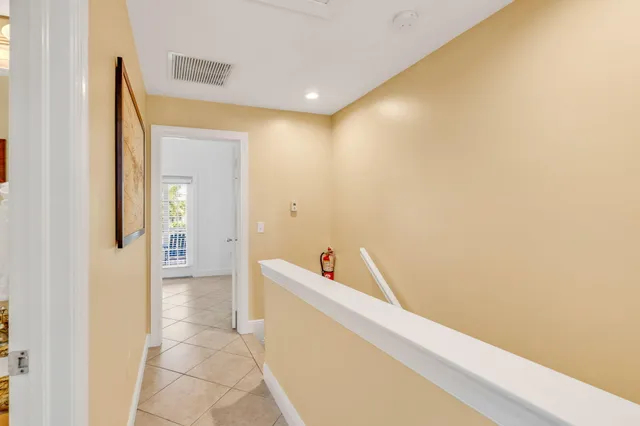 a view of a room that has a bed and a dresser