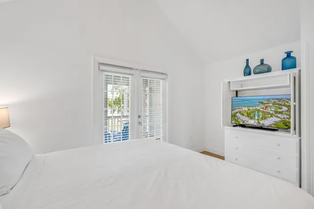 a bedroom with a bed and a large window