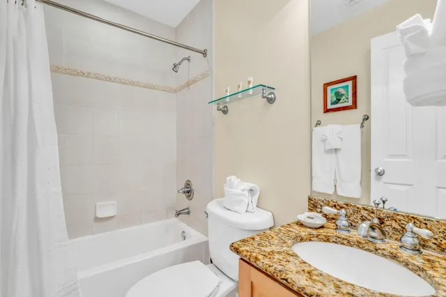 a view of a house with a yard and coconut trees