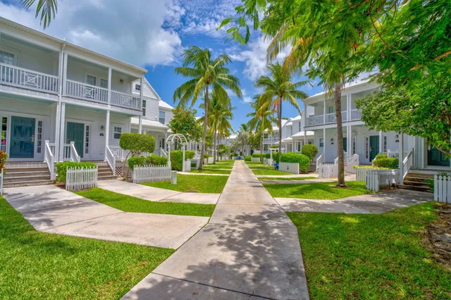 a front view of a building with garden and porch