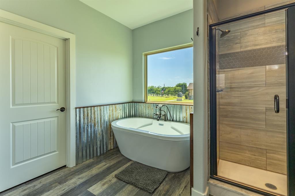14910 Old Stoney Road Ponder, TX 76259 - Photo 21 of 36 a bathroom with a bathtub and shower