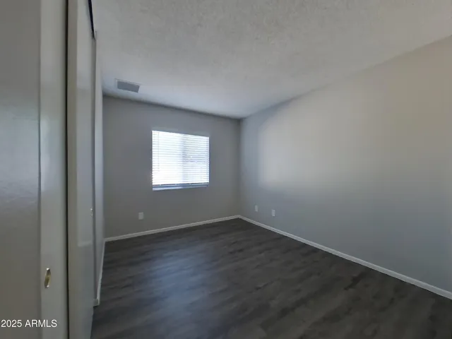 a bathroom with a granite countertop sink toilet and a mirror
