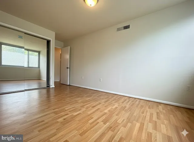 a view of an empty room and wooden floor