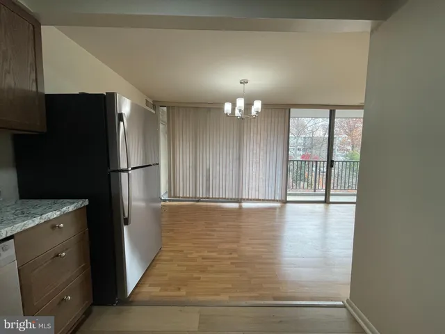 a view of a kitchen with a sink and refrigerator
