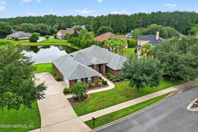 an aerial view of a house with garden space and street view
