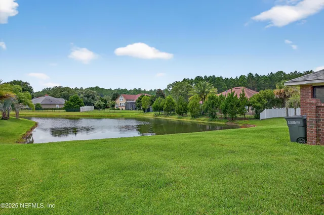 a view of a lake with a house in the background