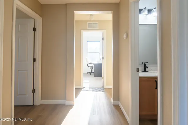 a view of a bathroom from a hallway