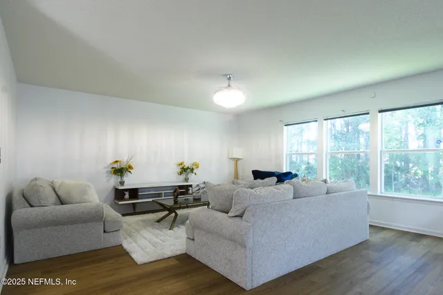 a living room with furniture and a large window