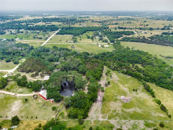 an aerial view of residential houses with outdoor space and swimming pool