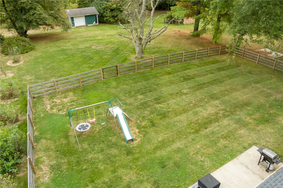6950 Red Lion 5 Points Road Springboro, OH 45066 - Photo 70 of 78 This expansive, fenced yard offers ample space for outdoor enjoyment and includes a dedicated play area.