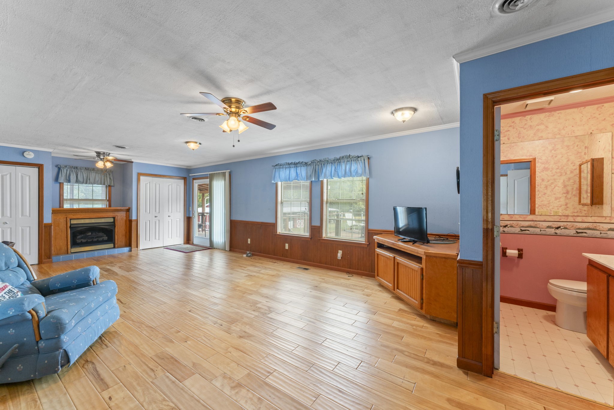 6737 Windrow Road Rockvale, TN 37153 - Photo 17 of 49 a large living room with stainless steel appliances granite countertop a stove a sink a refrigerator and a fireplace with wooden floor