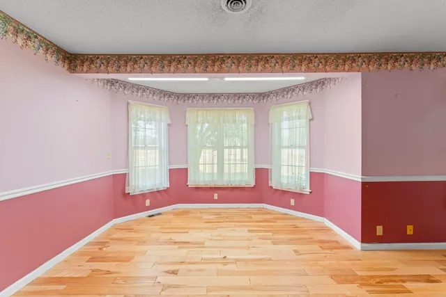a view of empty room with a fireplace