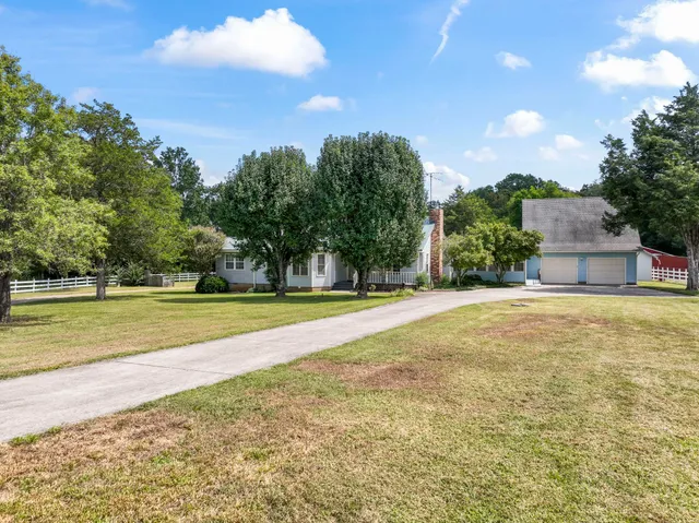 a view of a swimming pool with an outdoor seating and a garden