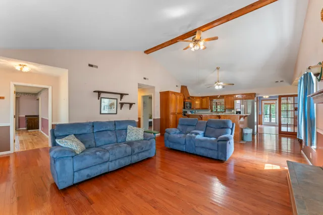 a room with kitchen island a large window and cabinets