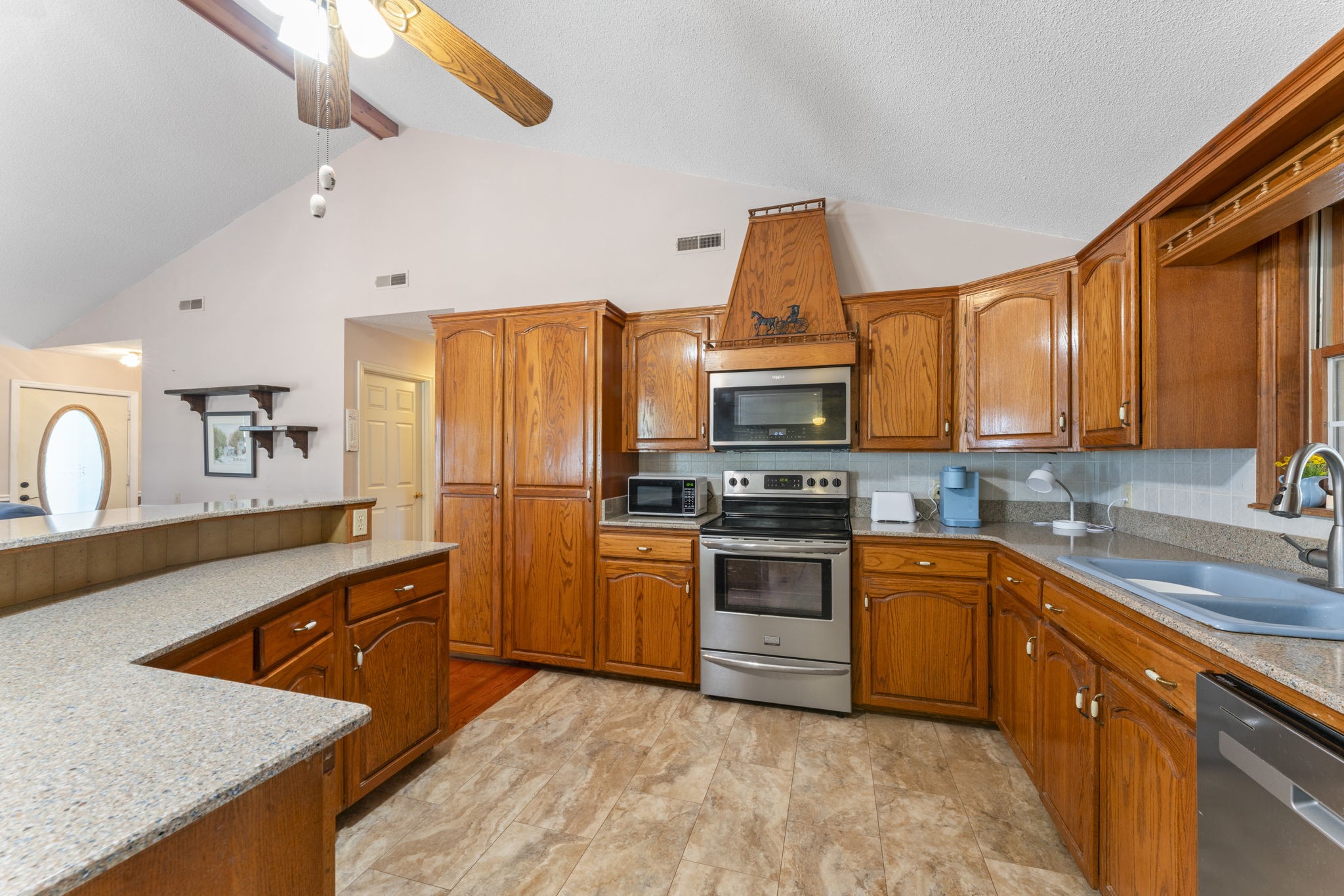 6737 Windrow Road Rockvale, TN 37153 - Photo 10 of 49 a kitchen with stainless steel appliances granite countertop a sink stove refrigerator and microwave
