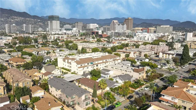 an aerial view of residential building with green space