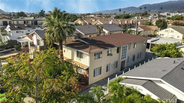 an aerial view of residential houses with yard