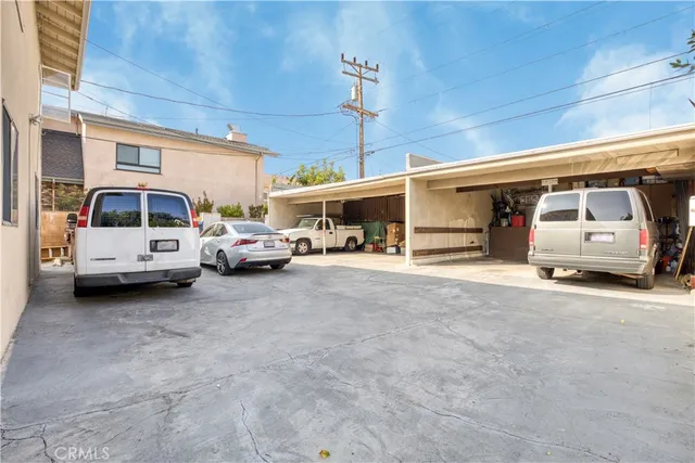 an aerial view of residential houses with outdoor space and street view